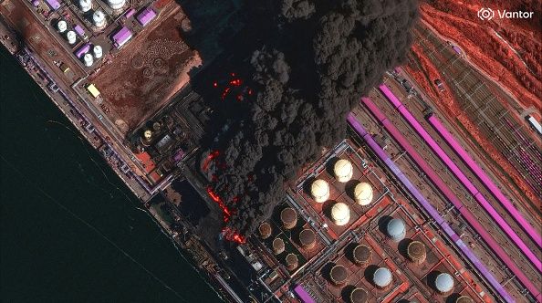 UST-LUGA OIL TERMINAL COMPLEX, NORTHERN RUSSIA -- MARCH 27, 2026: 03 -- Vantor near-infrared satellite image shows large fire burning multiple oil storage tanks at Ust-Luga oil terminal complex with thick black smoke drifting east. Please use: Satellite image (c) 2026 Vantor.Maxar