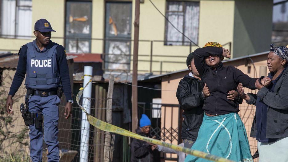 arch51
TOPSHOT - A relative of one of the victims cries as south African Police Service officers refuse to let her cross the police barrier and enter the crime scene in Soweto, South Africa, on July 10, 2022. - Fourteen people were killed during a shootout in a bar in Soweto police said on July 10, 2022.
Police lieutenant Elias Mawela said that they were called in the early hours in the morning, around 12:30am after the shooting overnight Saturday and Sunday.
When police arrived at the scene, 12 people were confirmed dead.
11 others were taken to hospital with wounds but two later died, raising the death toll to 14. (Photo by Ihsaan HAFFEJEE / AFP)
IHSAAN HAFFEJEE