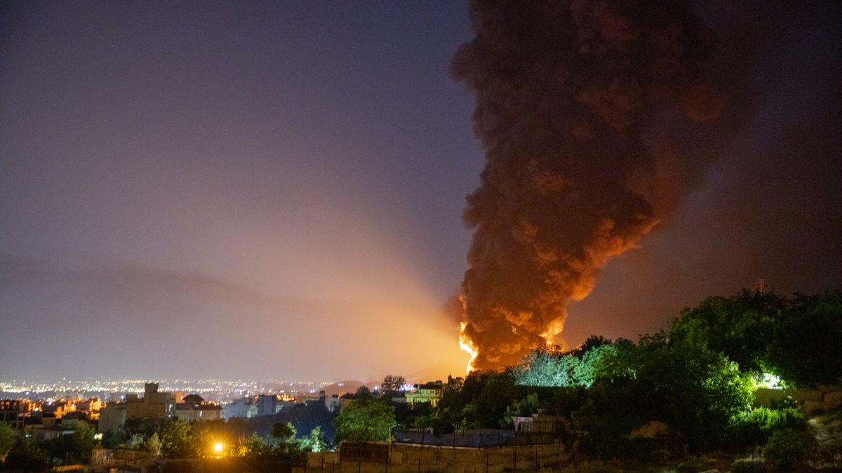 TEHRAN, IRAN - JUNE 15: Fire and smoke rise into the sky after an Israeli attack on the Shahran oil depot on June 15, 2025 in Tehran, Iran. Iran's foreign minister said the country would respond decisively and proportionally to a wave of attacks that Israel launched beginning in the early hours of June 13. The attacks targeted multiple military, scientific and residential locations, as well as senior government officials. (Photo by Stringer/Getty Images)