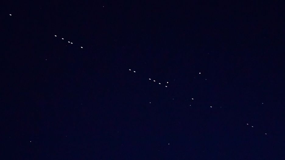 VLADIVOSTOK, RUSSIA - APRIL 27, 2020: 60 of the Starlink Internet communication satellites of Elon Musk's SpaceX private spaceflight company seen in the night sky. On April 22, 2020, SpaceX successfully launched 60 Starlink satellites into orbit on the Falcon 9 rocket from NASA's Kennedy Space Center at Cape Canaveral. The Starlink project is aimed at providing low-cost internet to remote locations; SpaceX is planning to launch into orbit about 30,000 satellites. Following the launch of the first batch of the Starlink satellites, the International Astronomical Union (IAU) and the US National Radio Astronomy Observatory (NRAO) expressed concerns about the satellites being too bright and forming a 'megaconstellation' and thus causing serious problems for astronomers.  Yuri Smityuk/TASS (Photo by Yuri Smityuk\TASS via Getty Images)