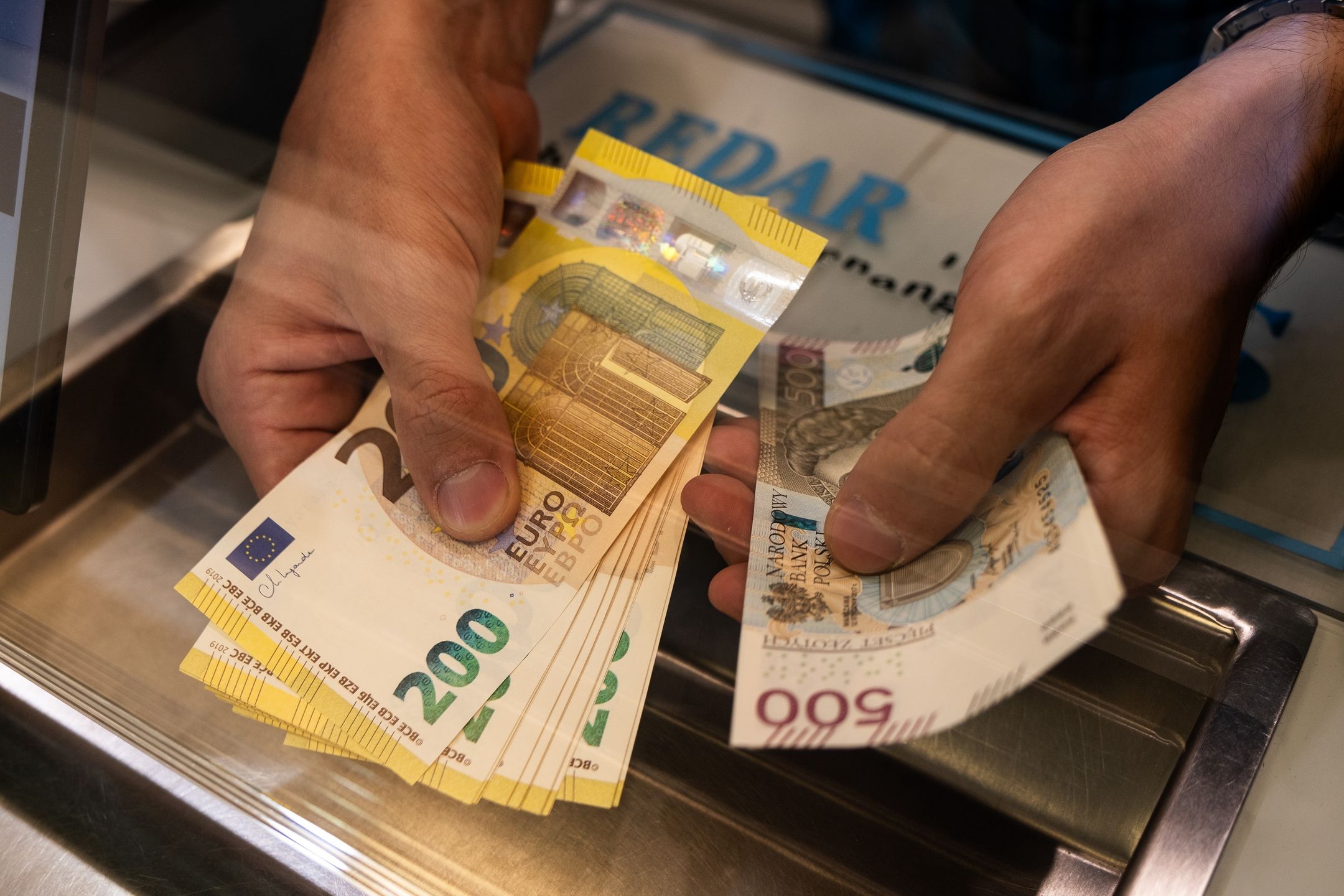 Euro and Polish zloty banknotes being cunted at a foreign currency exchange bureau in Warsaw, Poland, on Wednesday, May 7, 2025. Poland's central bank cut interest rates for the first time since October 2023 as eastern Europe's biggest economy prepares to elect a new president in a little over a week's time. Photographer: Damian Lemanski/Bloomberg via Getty Images