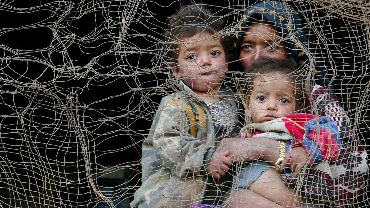 Bamiyan Cave Dwellers401473 13: A mother and her two children look out from inside their cave dwelling February 23, 2002 in Bamiyan, Afghanistan. About 60 families live in caves that are adjacent to the destroyed ancient Buddha statues in Bamiyan. The cave dwellers have reestablished their homes after fleeing from Taliban rule. (Photo by Paula Bronstein/Getty Images)Paula Bronsteinafghanistan bamiyan cave home living taliban war
