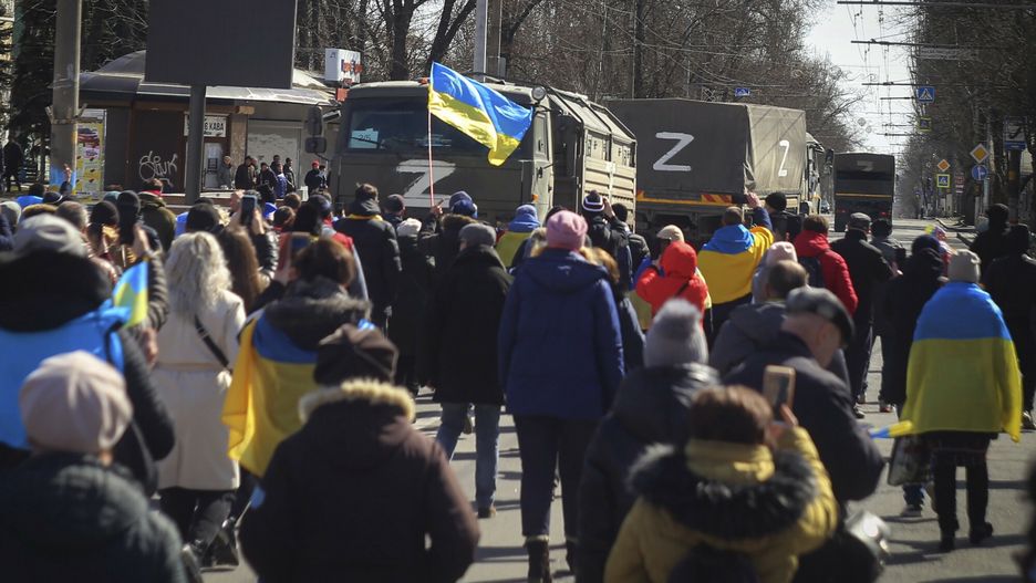 TemporaryPeople with Ukrainian flags walk towards Russian army trucks during a rally against the Russian occupation in Kherson, Ukraine, Sunday, March 20, 2022. Ever since Russian forces took the southern Ukrainian city of Kherson in early March, residents sensed the occupiers had a special plan for their town. Now, amid a crescendo of warnings from Ukraine that Russia plans to stage a sham referendum to transform the territory into a pro-Moscow "people's republic," it appears locals guessed right. (AP Photo/Olexandr Chornyi)AP