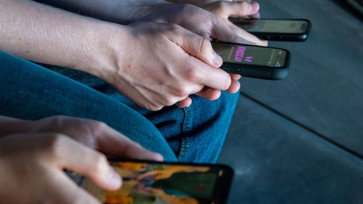 MORZINE, FRANCE - APRIL 11: Three teenage boys looks at their smartphone screens in village of St Jean d'Aulps on April 11, 2025 near Morzine, France. In the UK, a ban on social media for under-16s has been backed by the House of Lords following the Australian law which aims to stop children under 16 from having social media accounts and social media platforms. The amount of time children spend on screens each day rocketed during the Covid pandemic by more than 50 per cent and researchers say that unmoderated screen time can have long-lasting effects on a child's mental and physical health. Recently TikTok announced that every account belonging to a user below age 18 have a 60-minute daily screen time limit automatically set. (Photo by Matt Cardy/Getty Images)
