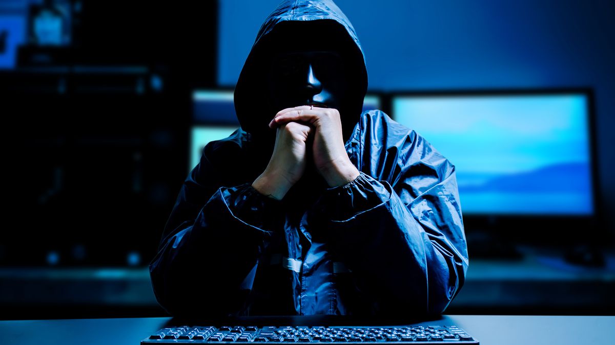 Anonymous computer hacker in white mask and hoodie. Obscured dark face with keyboard computer in the dark. Data thief, internet attack, darknet and cyber security concept.Anonymous computer hacker in white mask and hoodie. Obscured dark face with keyboard computer in the dark. Data thief, internet attack, darknet and cyber security concept.chingyunsonganonymous, attack, background, code, concept, cyber, digital, fraud, gesture, hack, hacker, hacking, hood, illegal, information, male, man, mask, network, online, person, professional, programmer, quiet, room, scam, secret, server, steal, system, threat, web