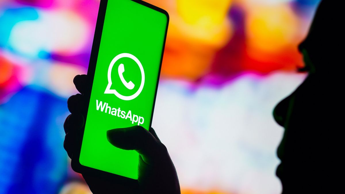 BRAZIL - 2022/10/17: In this photo illustration, a silhouetted woman holds a smartphone with the WhatsApp logo displayed on the screen. (Photo Illustration by Rafael Henrique/SOPA Images/LightRocket via Getty Images)