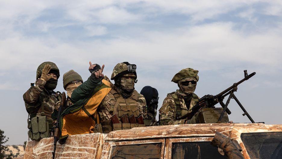 HAMA, SYRIA - DECEMBER 6: National Syrian Army soldiers celebrate in the city after opposition forces led by HTS (Hayyet Tahrir al-Sham) took control of Hama city center and surrounding villages on December 6, 2024 in Hama, Syria. (Photo by Ugur Yildirim/ dia images via Getty Images)