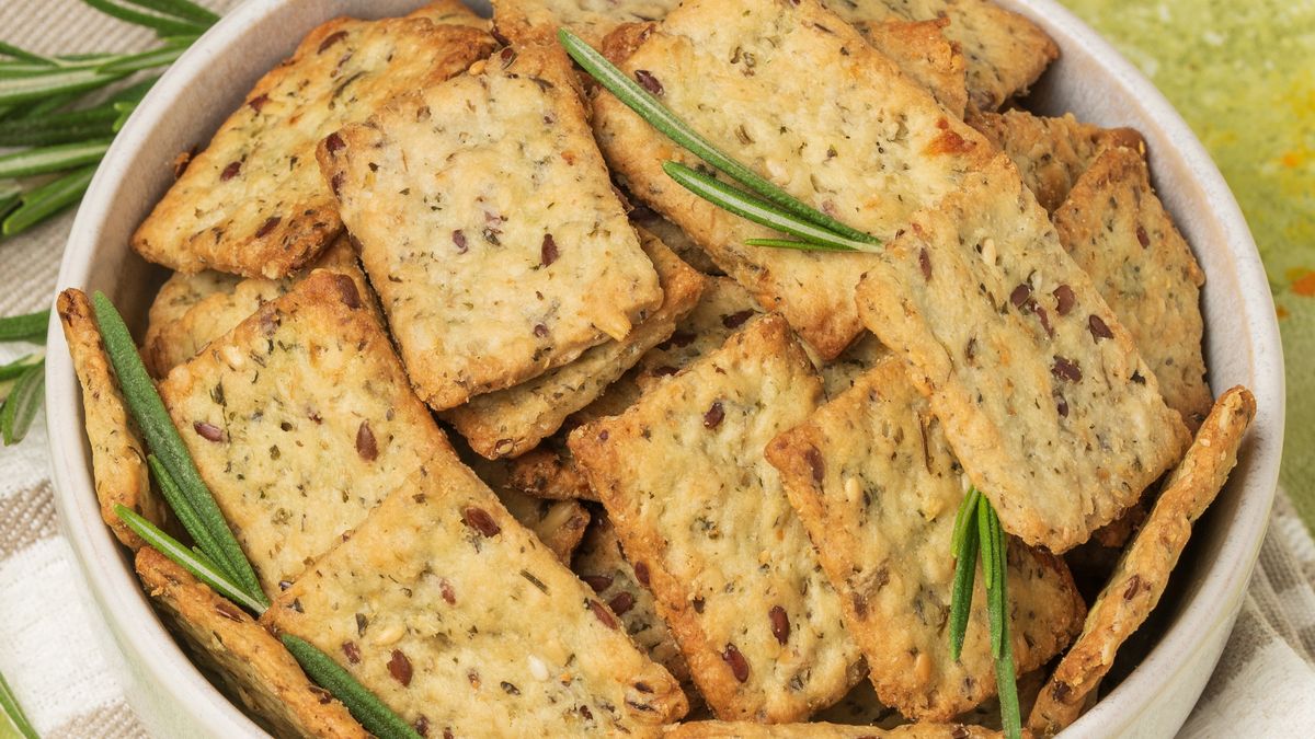 Homemade diet cookies with herbs, leenseed and spices  in a light plate on  green table. Crunchy rosemary crackers top view, close up plandiet cookies, herbal, rosemary crackers, healthy pastries, top view, healthy snacks, herbs, crispy, crunchy, leenseed, baked, biscuit, bread, ligtht background, vegetable loaves, flatbread, breakfast, cookies, dry, flavorful, fried, rustic, salty, savory, sweet, texture, thin, wheat, white, diet cookies, herbal, rosemary crackers, healthy pastries, top view, healthy snacks, herbs, crispy, crunchy, flax seeds, baked, biscuit, bread, green background, vegetable loaves, flatbread, breakfast, cookies, dry, flavorful, fried, rustic, salty, savory, sweet, texture, thin, wheat, white