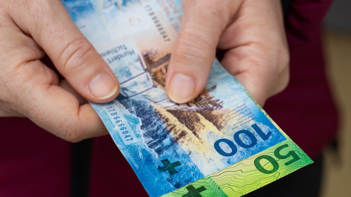The woman holds Swiss money, 100 and 50 franc banknotesThe woman holds Swiss money, 100 and 50 franc banknotesAndrzej Rostekfr, pbackground