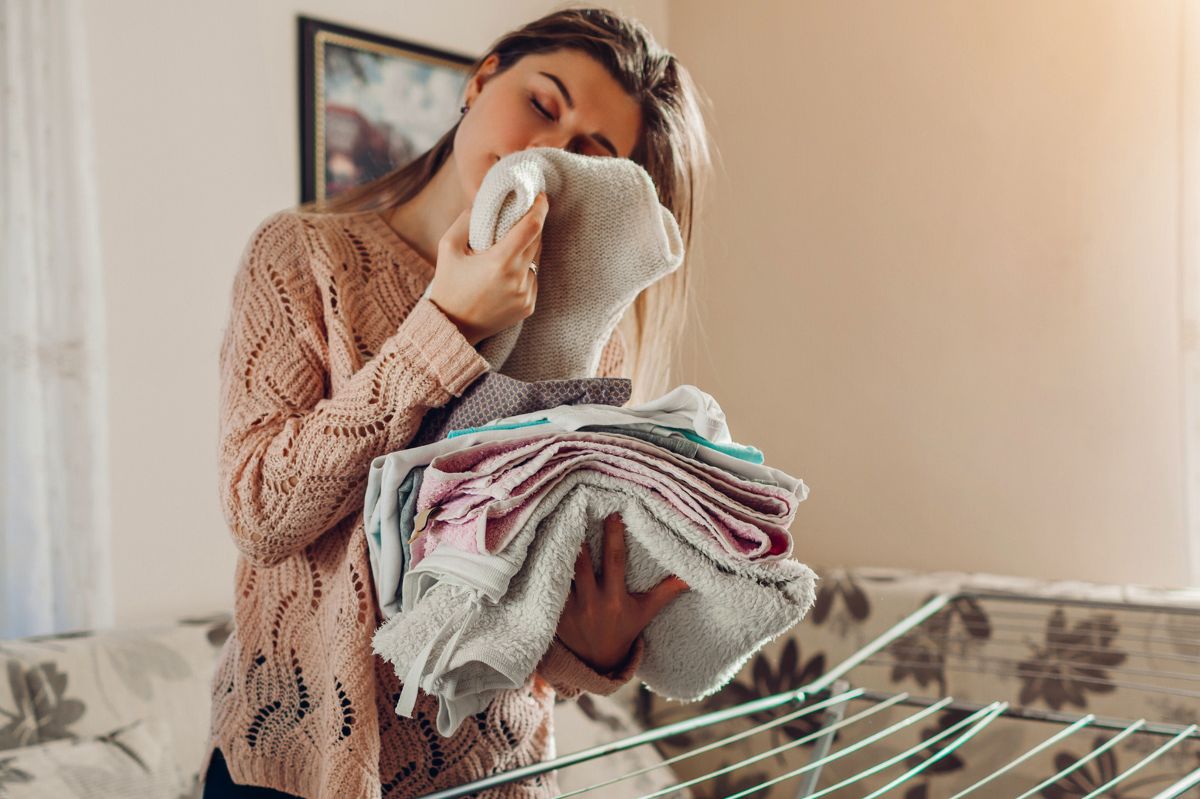 The woman smells the laundry.