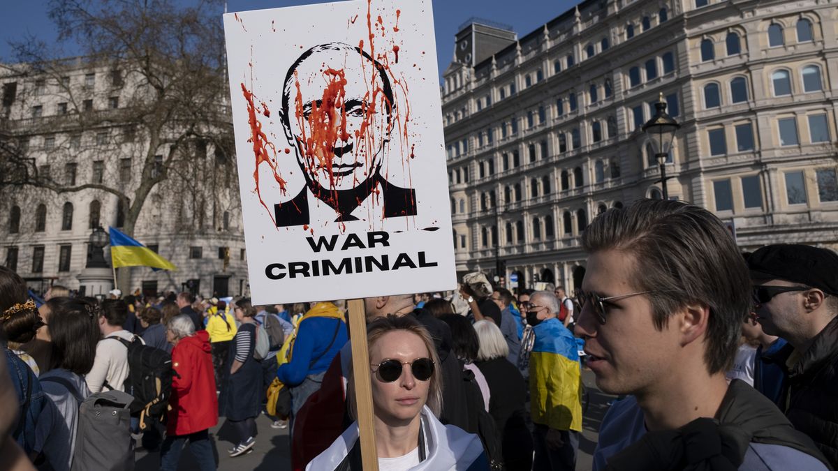 Image of Russian president Vladimir Putin described as a war criminal as thousands of people gather in the capital for a peace march London stands with Ukraine in solidarity with the people of Ukraine on 26th March 2022 in London, United Kingdom. The conflict in Ukraine is now in its second month and their president has called for people across the World to unite in protest at the Russian invasion and ongoing war in the region. The Ukrainian flag of yellow and blue was everywhere to be seen in this colourful show of unity. (photo by Mike Kemp/In Pictures via Getty Images)