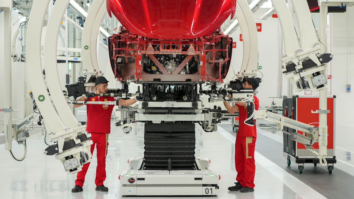 Workers on the production line at the new Ferrari NV E-building factory in Maranello, Italy, on Friday, June 21, 2024. The site in Maranello, built over the past couple of years in near-total secrecy, will make Ferrari's first EV from late 2025 alongside hybrid models and cars powered by combustion engines. Photographer: Francesca Volpi/Bloomberg via Getty Images