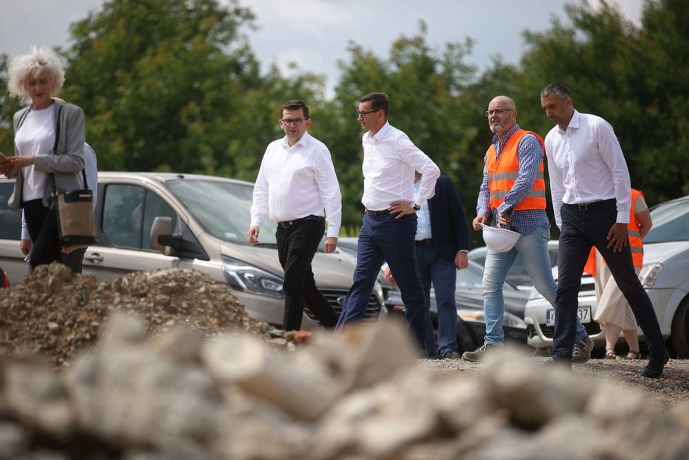 <p>Kraków, 19.07.2021. Premier Mateusz Morawiecki (3P), wicemarsza³ek Senatu Marek Pêk (P) i wojewoda ma³opolski £ukasz Kmita (4P) podczas wizyty na budowie obwodnicy Krakowa, 19 bm. (aldg) PAP/£ukasz G¹gulski</p>