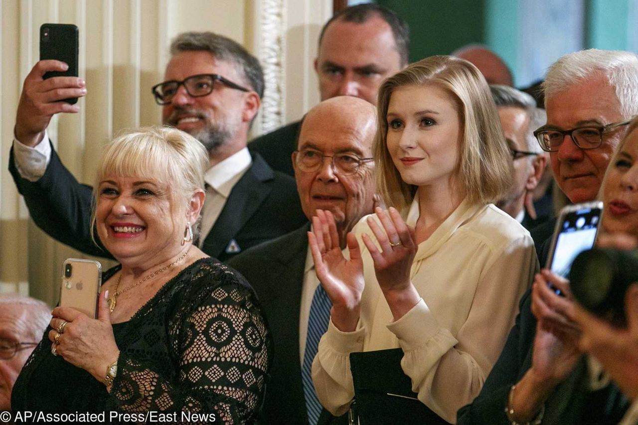 Kinga Duda, daughter of Polish President Andrzej Duda, right, applauds as she stands next to Commerce Secretary Wilbur Ross during a Polish-American reception where President Donald Trump and Polish President Andrzej Duda spoke in the East Room of the White House, Wednesday June 12, 2019. (AP Photo/Jacquelyn Martin)