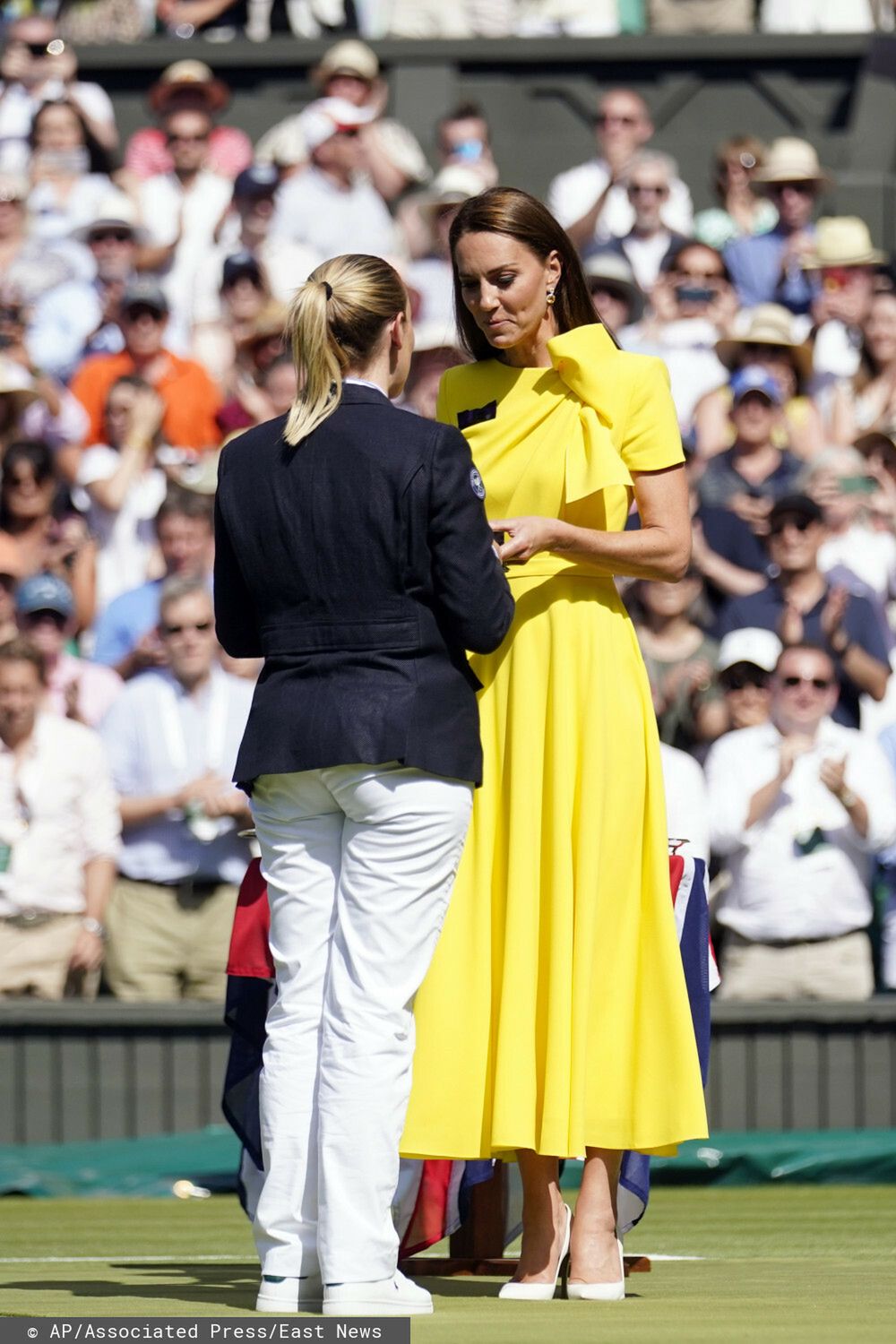 Britain's Kate, Duchess of Cambridge speaks with the umpire after the women's singles final between Kazakhstan's Elena Rybakina and Tunisia's Ons Jabeur on day thirteen of the Wimbledon tennis championships in London, Saturday, July 9, 2022. (AP Photo/Gerald Herbert)