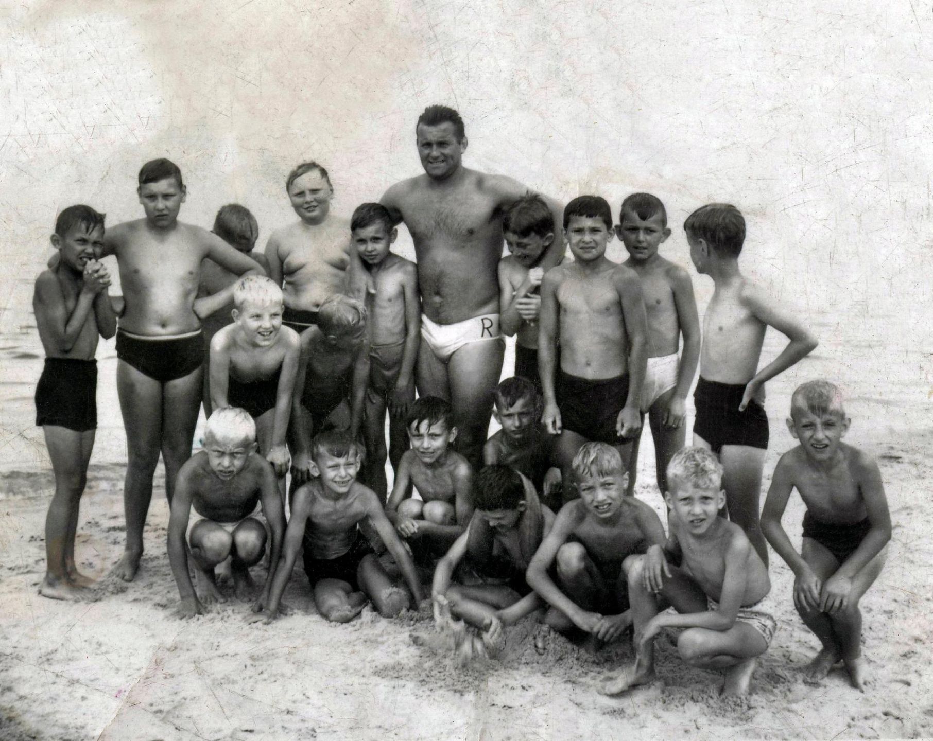 Kolonie w PRL - Mrzezyno, 1967. Kolonia letnia Zjednoczenia Przemyslu w Zielonej Gorze. Ratownik z grupa chlopców.