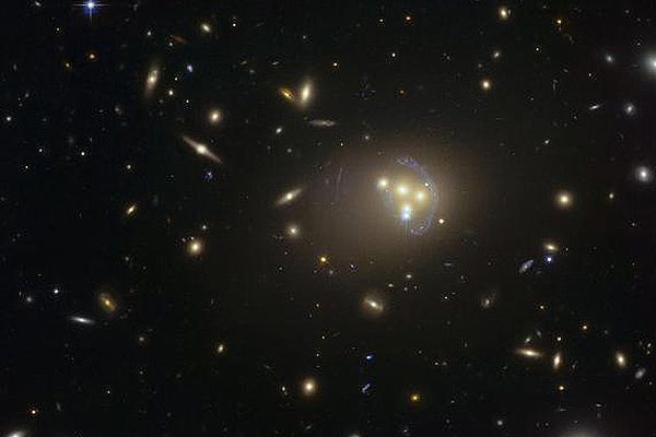 Zdjęcie gromady galaktyk Abell 3827 wykonane za pomocą Kosmicznego Teleskopu Hubble&#8217;a. Dziwne niebieskie struktury wokół centralnych galaktyk to obrazy soczekowania grawitacyjnego znacznie odleglejszej galaktyki.