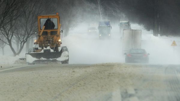 Silny wiatr nawiewa śnieg z pól, jezdnia jest oblodzona