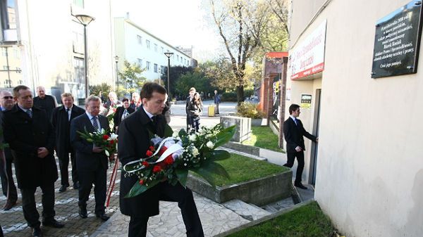 Mariusz Błaszczak składa kwiaty przed pamiątkową tablicą