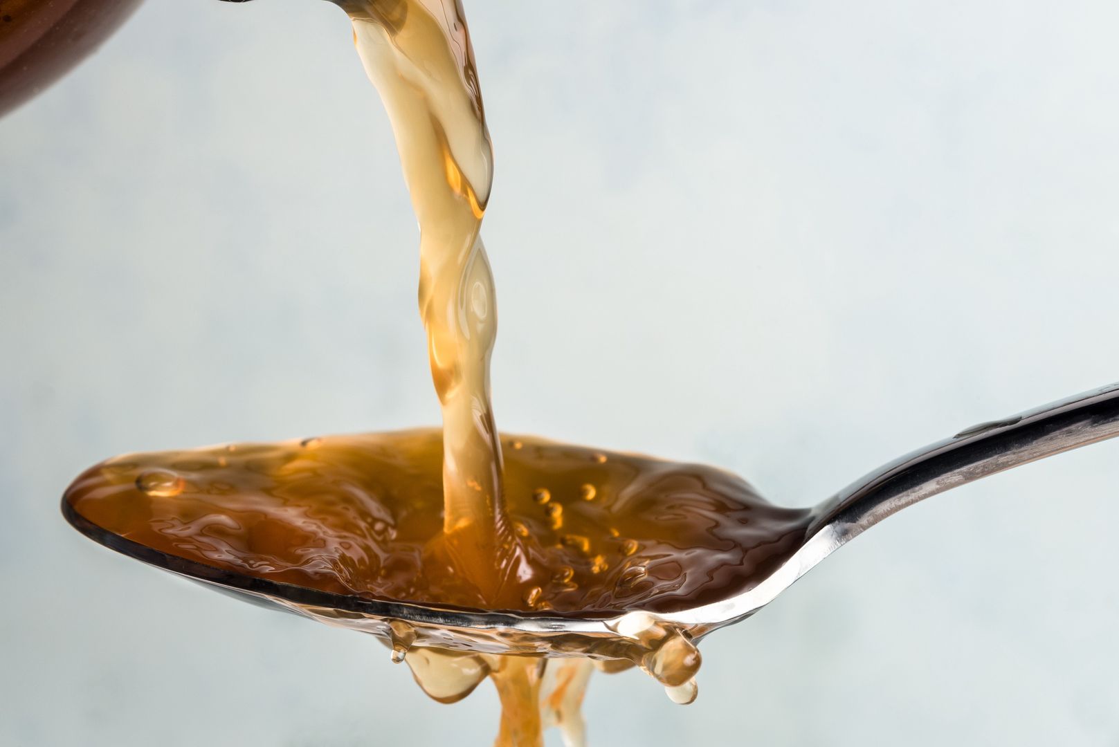 Pouring Apple Cider Vinegar on a SpoonPouring Apple Cider Vinegar on a SpoonMichelle Lee Photographyisolated, nobody, macro, apple, pour, action