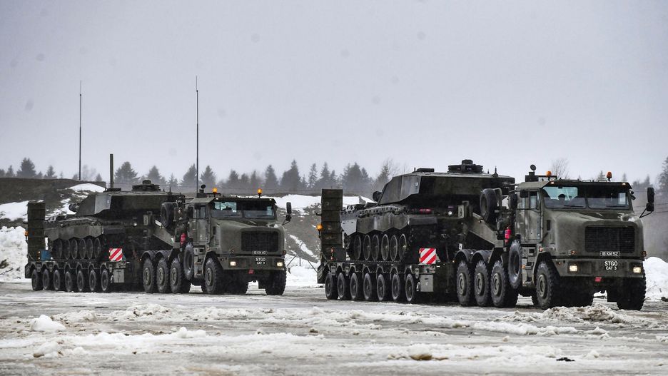 TemporaryMilitary trucks carry tanks as a part of additional British troops and military equipment upon their arrival at Estonia's NATO Battle Group base in Tapa, Estonia, Friday, Feb. 25, 2022. The UK is sending an additional rotation - approximately 850 troops - to Estonia, doubling the size of its battlegroup contingent in the country. (AP Photo/Sergei Stepanov)AP