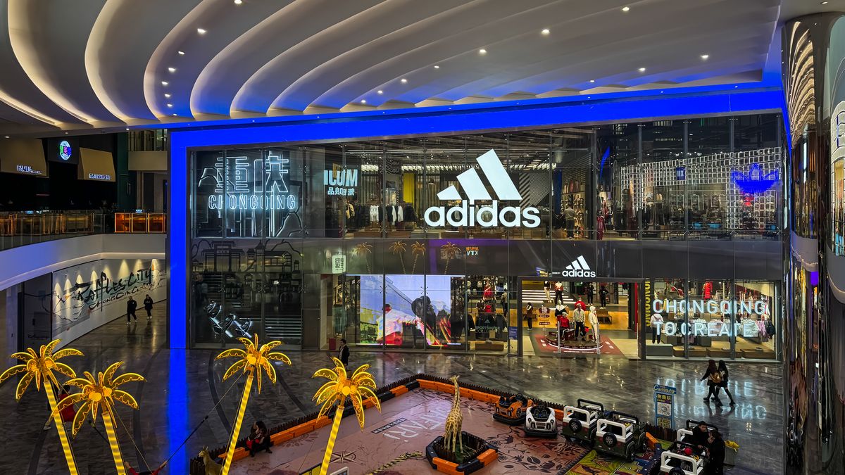 CHONGQING, CHINA - JANUARY 18: A view of the interior of a shopping mall featuring an Adidas flagship store with prominent signage, illuminated decor, and a children play area with toy cars and palm tree-themed decorations on January 18, 2025 in Chongqing, China. Chinas economy is the worlds second-largest, with a nominal GDP of approximately $13 trillion as of Q3 2024, reflecting a growth rate of 4.6% year-on-year despite challenges such as a struggling real estate sector and weak consumer demand. (Photo by Cheng Xin/Getty Images)