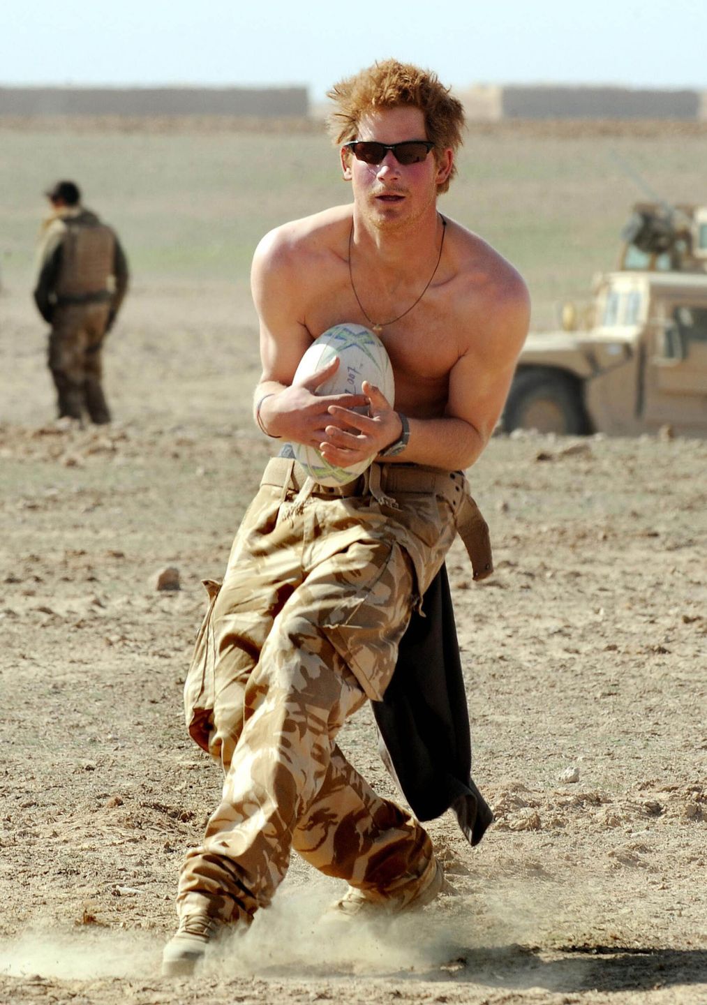 02/01/2008 - HELMAND PROVINCE -  AFGHANISTAN

PRINCE HARRY PRACTICES HIS RUGBY SKILLS WITH THE CREW OF HIS SPARTAN ARMOURED VECHICLE DURING A BREAK IN THEIR DUTIES IN THE DESERT IN HELMAND PROVINCE, SOUTHERN AFGHANISTAN.

BYLINE MUST READ: XPOSUREPHOTOS.COM

*NO UK USE UNTIL 02ND FEBRUARY 2008* *THIS IMAGE IS STRICTLY FOR PAPER AND MAGAZINE USE ONLY - NO WEB ALLOWED USAGE UNLESS PREVIOUSLY AGREED. PLEASE TELEPHONE 020 7377 2770*
