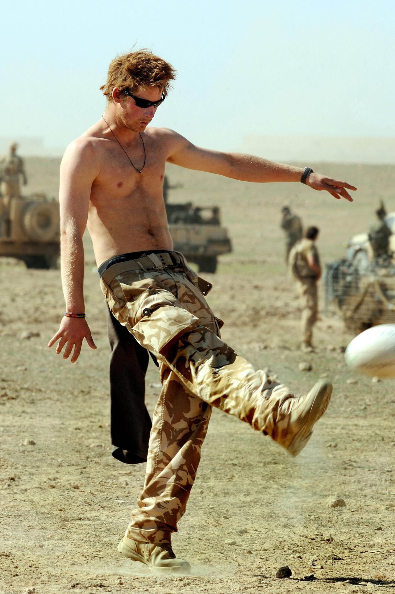 02/01/2008 - HELMAND PROVINCE -  AFGHANISTAN

PRINCE HARRY PRACTICES HIS RUGBY SKILLS WITH THE CREW OF HIS SPARTAN ARMOURED VECHICLE DURING A BREAK IN THEIR DUTIES IN THE DESERT IN HELMAND PROVINCE, SOUTHERN AFGHANISTAN.

BYLINE MUST READ: XPOSUREPHOTOS.COM

*NO UK USE UNTIL 02ND FEBRUARY 2008* *THIS IMAGE IS STRICTLY FOR PAPER AND MAGAZINE USE ONLY - NO WEB ALLOWED USAGE UNLESS PREVIOUSLY AGREED. PLEASE TELEPHONE 020 7377 2770*