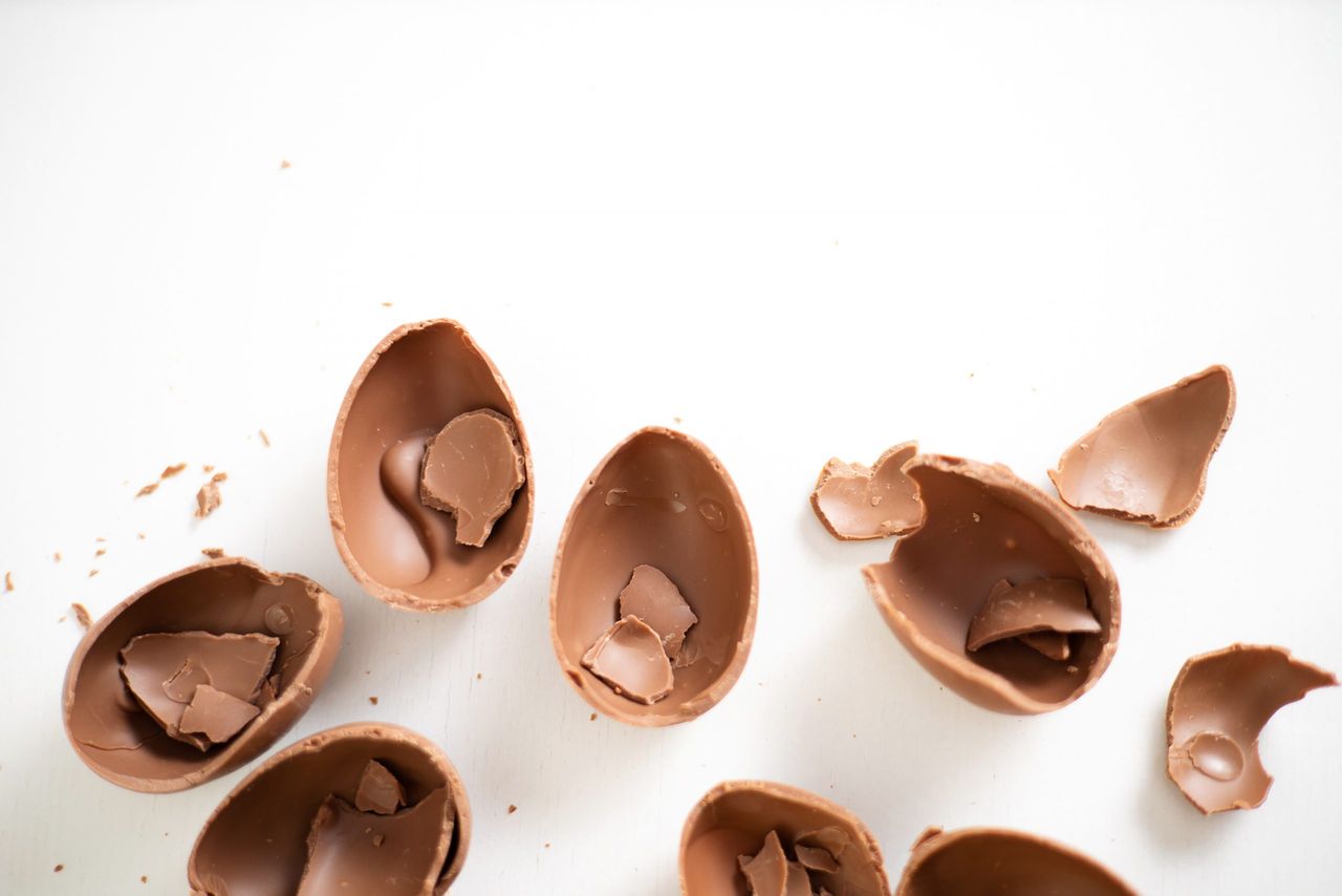 Happy Easter. Open broken crumbled destroyed chocolate eggs on a white background. Holiday. High quality photo