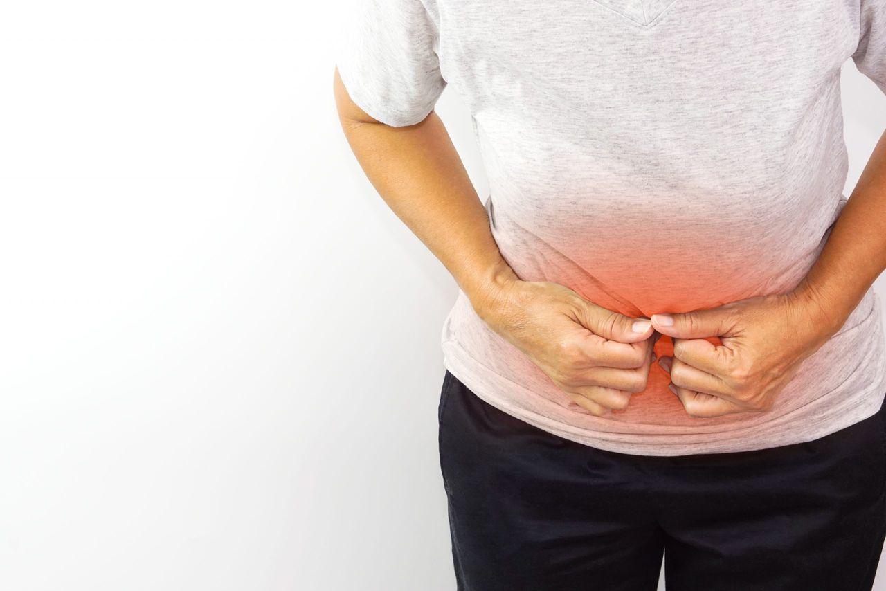 Woman suffering from stomachache. Chronic gastritis, menstruation and health concept.