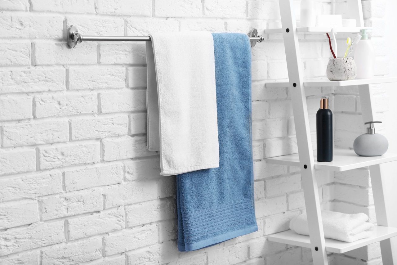 Clean towels on rack in bathroom
