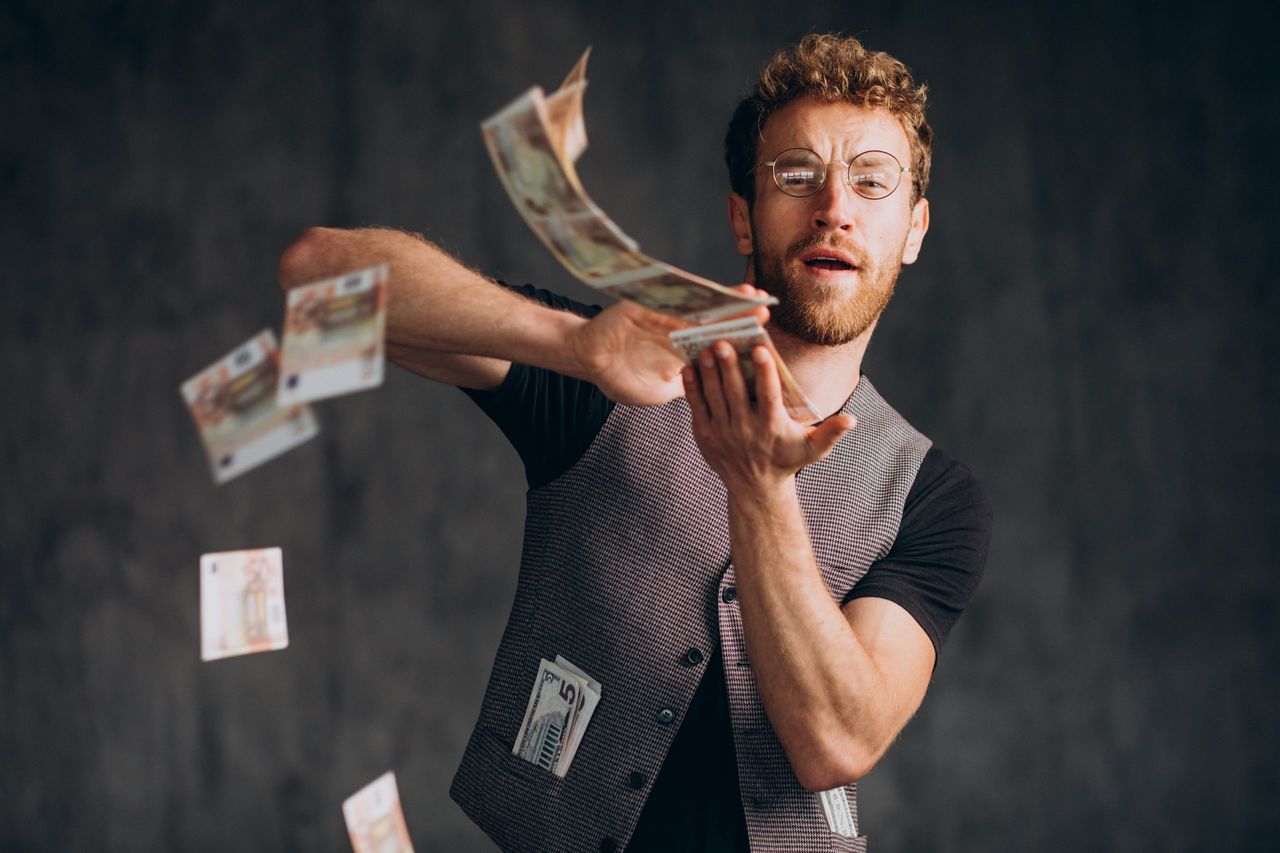 Man with banknotes isolated in studio