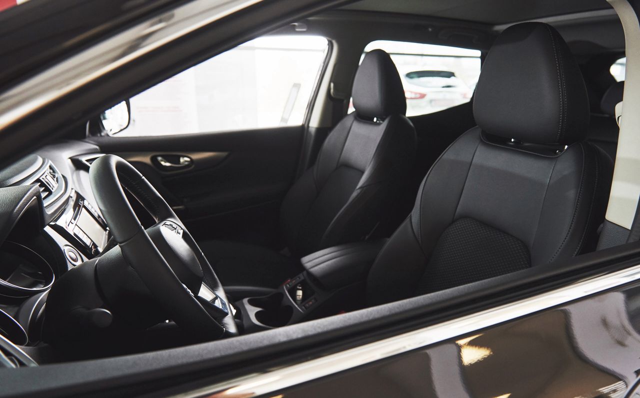 Dark luxury car Interior - steering wheel, shift lever and dashboard