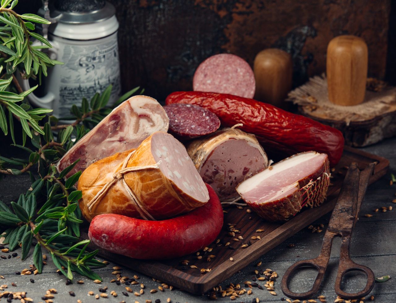 sausage assortment salami, pepperoni, ham on wooden board