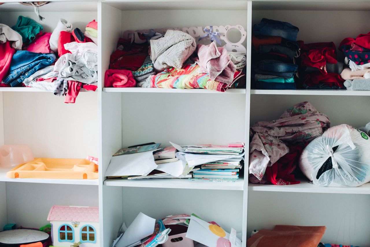 Picture of a white cupboard in which the clutter