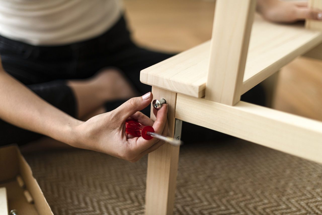 Woman assembling a diy chair from scratch