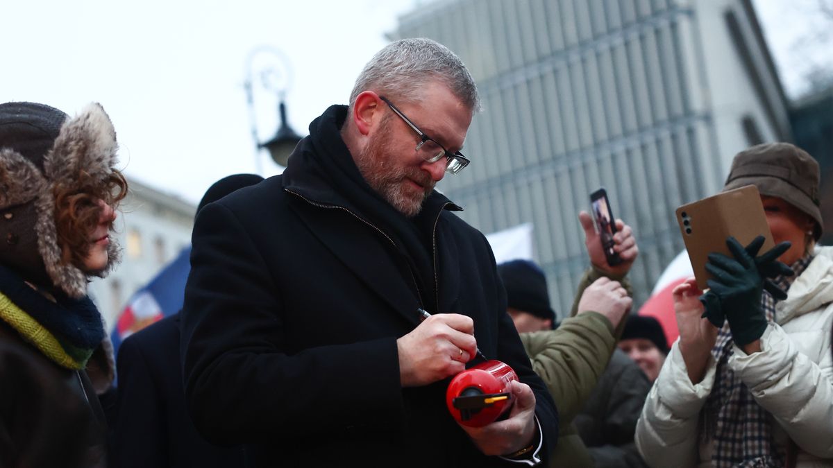 WARSAW, POLAND - DECEMBER 30: European Parliament member Grzegorz Braun signs a fire extinguisher during the anti-Hannukah protest near the parliament building in Warsaw, Poland on December 30, 2024. Demonstration is organised by the far-right at the time of the Hanukkah lightning ceremony in the parliament. In December 2023 MP Grzegorz Braun doused menorah by a fire extinguisher. (Photo by Jakub Porzycki/Anadolu via Getty Images)