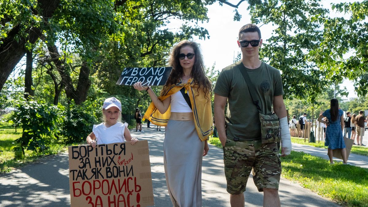 KYIV, UKRAINE - JUNE 30: Activists with a child attend the rally urging for the return of Ukrainian soldiers from Russian captivity on June 30, 2024 in Kyiv, Ukraine. The Free Azov rallies in support of the captured defenders of Mariupol regularly take place in Kyiv and other Ukrainian cities. The participants - activists and relatives of the POWs come out to remind people about the Ukrainian soldiers who have been held in Russian captivity for more than two years. (Photo by Oleksii Samsonov/Global Images Ukraine via Getty Images)