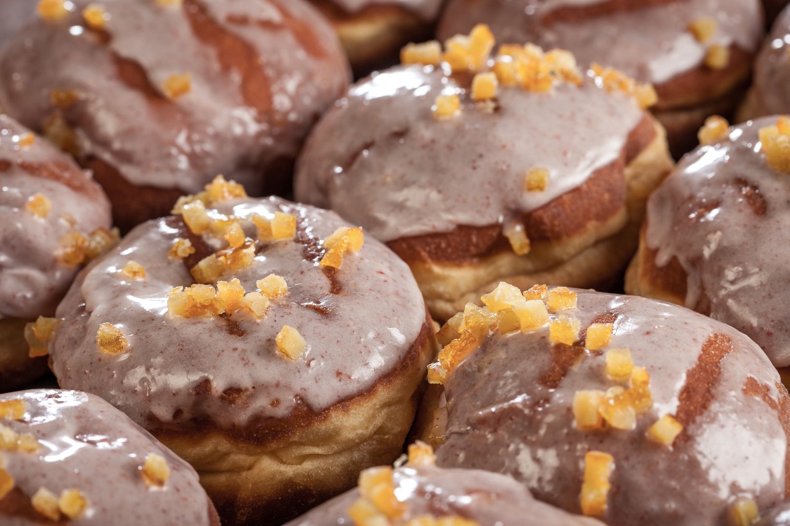 Fresh donuts with icing and orange peel
Close up of donuts with sugar icing and orange peel
Ohoho
