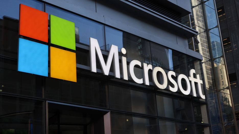 NEW YORK, NY - JUNE 24: A corporate logo for Microsoft hangs above the door to their office building on 8th Avenue on June 24, 2025, in New York City. (Photo by Gary Hershorn/Getty Images)