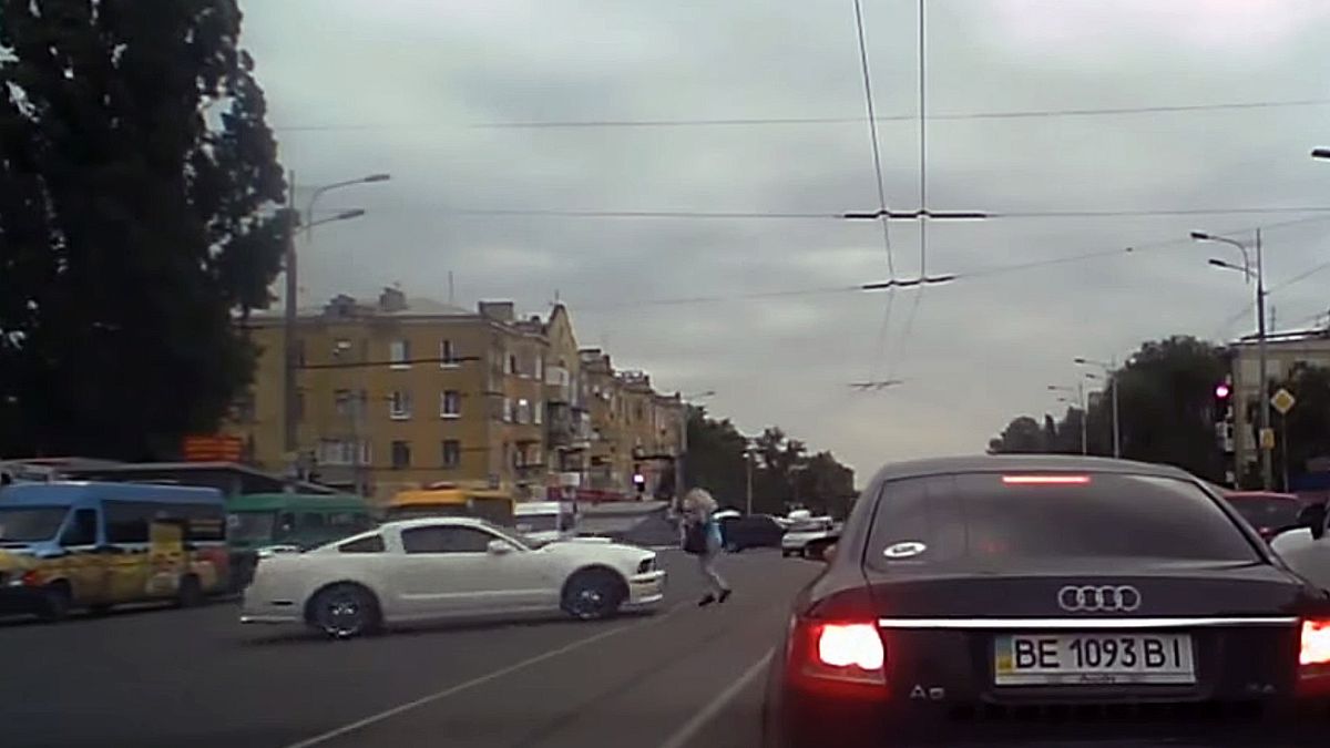 Ford Mustang idąc bokiem cudem omija pieszą na ulicy 1