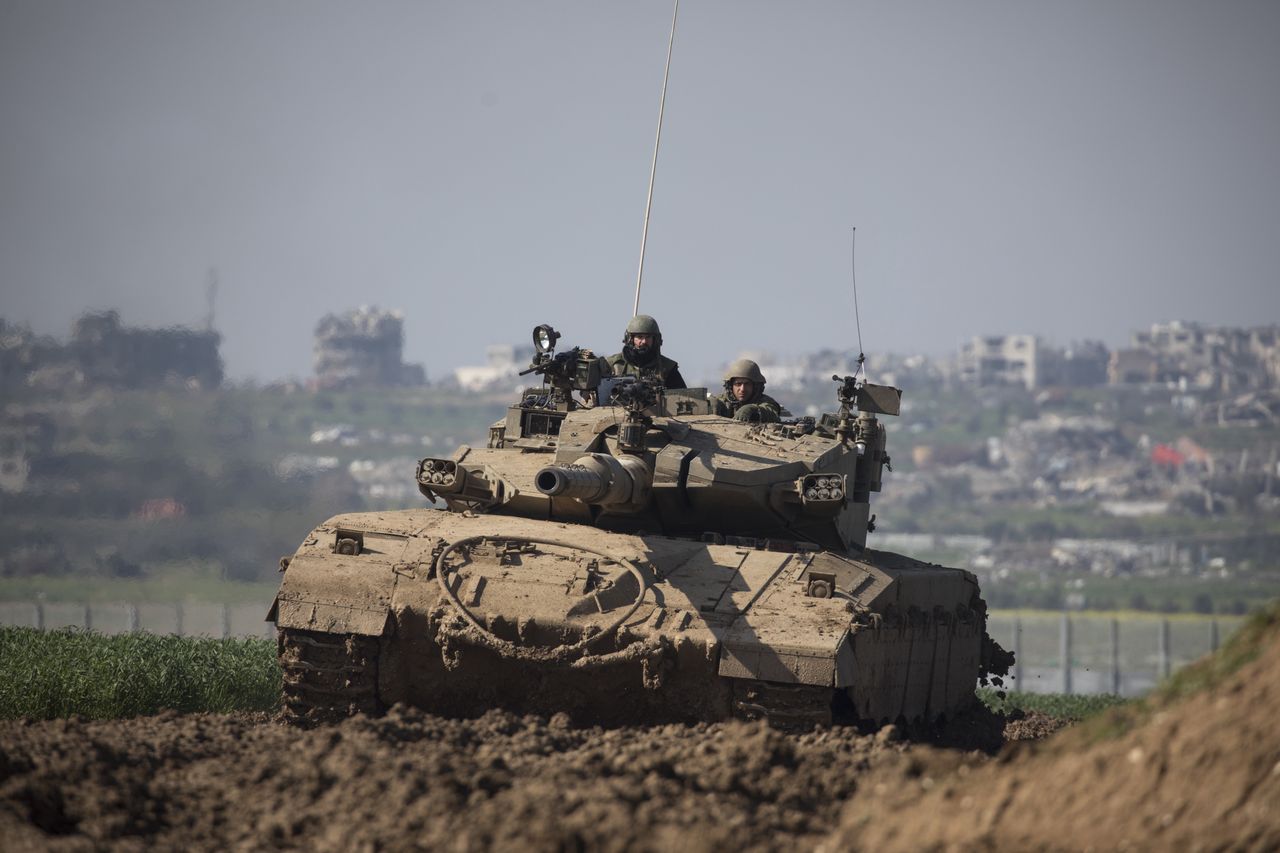 SOUTHERN ISRAEL, ISRAEL - FEBRUARY 06: An Israeli tank moves a long the border, as Gaza is seen behind on February 06, 2024 in Southern Israel, Israel. The Israeli prime minister's office referred to as "constructive" the recent high-level talks on a proposed pause in fighting in Gaza, as well as the release of Israeli hostages held there. The potential deal, which is being brokered by Qatar and Egypt, would also entail the release of Palestinian prisoners held in Israel and other conditions. (Photo by Amir Levy/Getty Images)