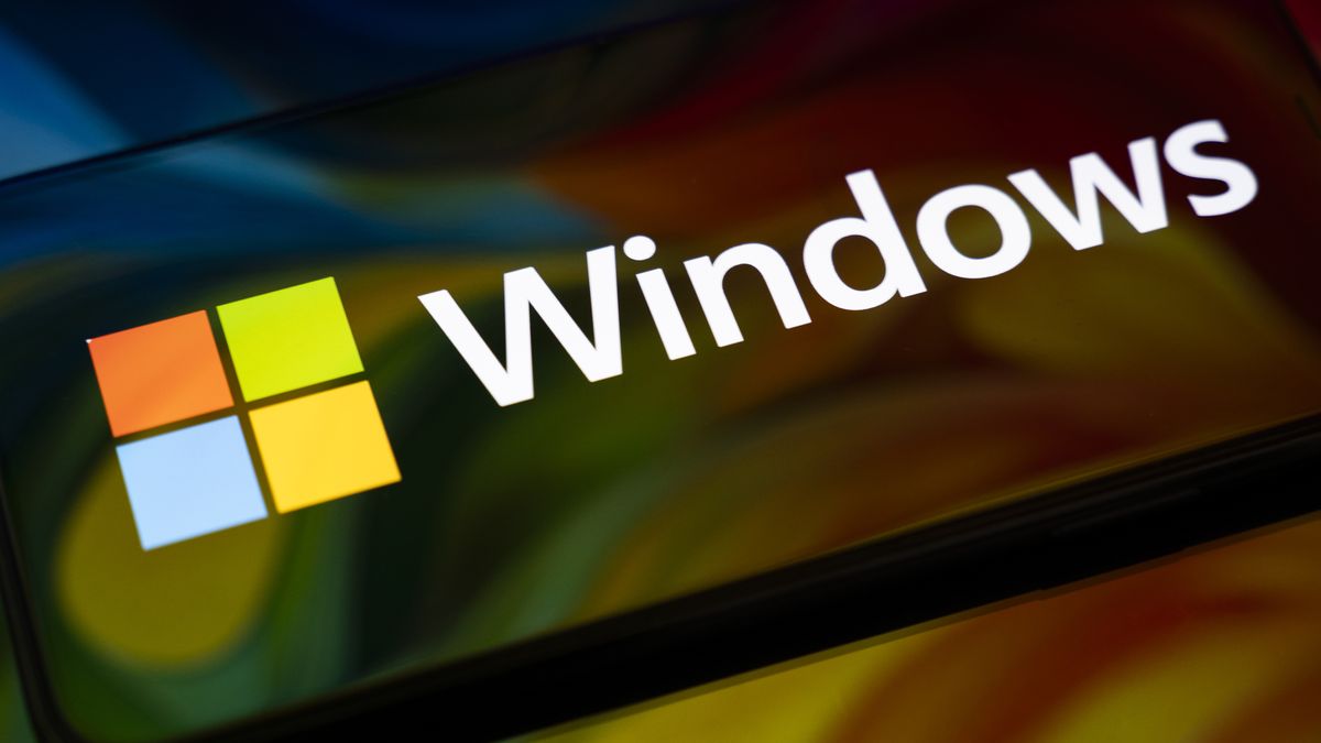 The Windows logo appears on the screen of a smartphone, which reflects an abstract illustration in Microsoft's colors of red, green, blue, and yellow. Microsoft releases a major update to Windows 11 (25H2), and support for Windows 10 ends definitively on October 14. In Creteil, France, on October 9, 2025. (Photo by Samuel Boivin/NurPhoto via Getty Images)
