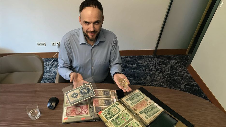 Mateusz Wójcicki z banknotami i monetami porzeniesionymi przez mieszkańców Krakow i dalszych okolic