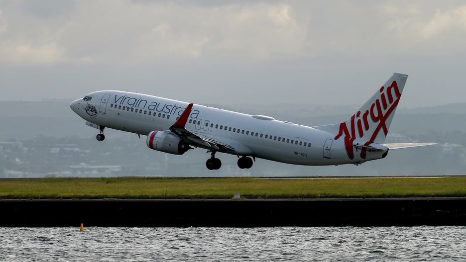 A Boeing Co. 737 aircraft operated by Virgin Australia Holdings Pty Ltd. takes off at Sydney Airport in Sydney, Australia, on Wednesday, Feb. 8, 2023. Virgin Australia is considering taking on new debt in order to hand cash to owner Bain Capital just months ahead of the airline's prospective initial public offering, according to people familiar with the matter. Photographer: Brendon Thorne/Bloomberg via Getty Images