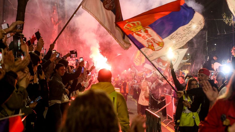 BELGRADE, SERBIA - MARCH 14: Demonstrators wave Serbian flags as they gather behind barricades in Belgrade, Serbia, on March 14, 2025, ahead of a large protest against the government. The demonstration comes in response to last year's train station collapse, which claimed 15 lives. Participants from various cities arrived by walking, running, or cycling, receiving applause upon their arrival. (Photo by Filip Stevanovic/Anadolu via Getty Images)