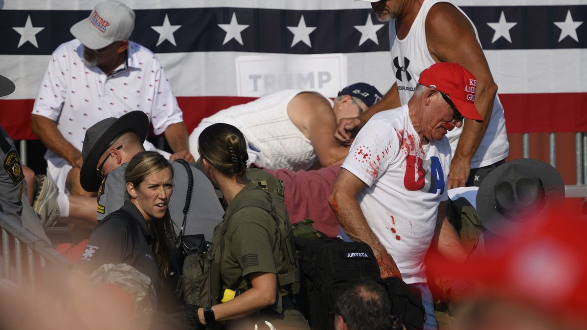 BUTLER, PENNSYLVANIA - JULY 13: Audience members duck in the crowd during a shooting attempt at a campaign rally for Republican presidential candidate, former U.S. President Donald Trump at Butler Farm Show Inc. on July 13, 2024 in Butler, Pennsylvania. According to Butler County District Attorney Richard Goldinger, the suspected gunman is dead after injuring former President Trump, killing one audience member and injuring at least one other. (Photo by Jeff Swensen/Getty Images)