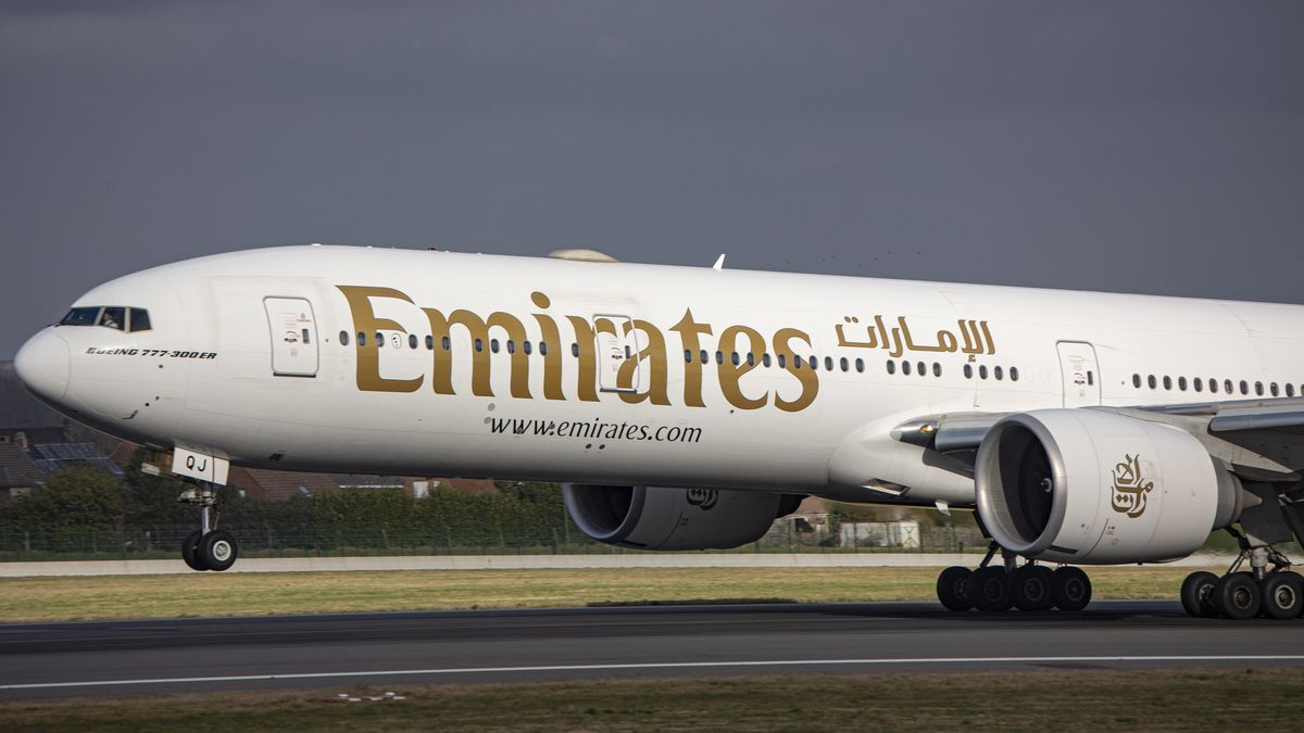 Emirates Boeing 777 aircraft as seen flying and landing on the runway with the control tower and the clouds in the background. Emirates B777 airplane as seen on final approach flying, landing and taxiing at the Belgian capital, Brussels Airport Zaventem BRU. The Boeing Boeing 777-31HER modern and advanced wide-body passenger airplane has the registration A6-EQJ and is powered by 2x GE90 jet engines. The plane is arriving at the European city from Dubai DXB, UAE. Emirates is largest airline and one of the two, flag carrier of the United Arab Emirates. The aviation industry and passenger traffic are phasing a difficult period with the Covid-19 coronavirus pandemic having a negative impact on the travel business industry with fears of a deteriorating situation due to the Delta and Omicron variant mutation at the fifth wave. Brussels, Belgium on January 30, 2022 (Photo by Nicolas Economou/NurPhoto via Getty Images)
