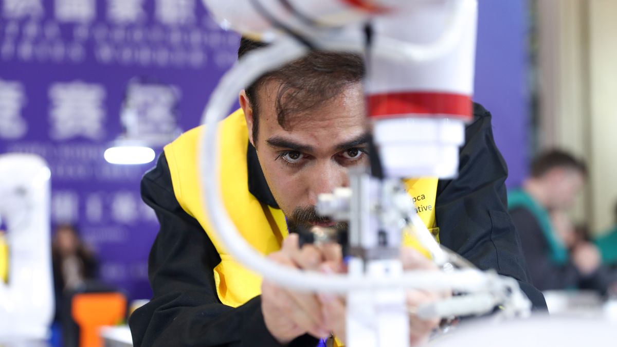 QINGDAO, CHINA - DECEMBER 18: A participant competes in intelligent manufacture and measuring system contest during the third SCO Countries Worker Skills Contest on December 18, 2024 in Qingdao, Shandong Province of China. (Photo by Zhang Xiangyi/China News Service/VCG via Getty Images)