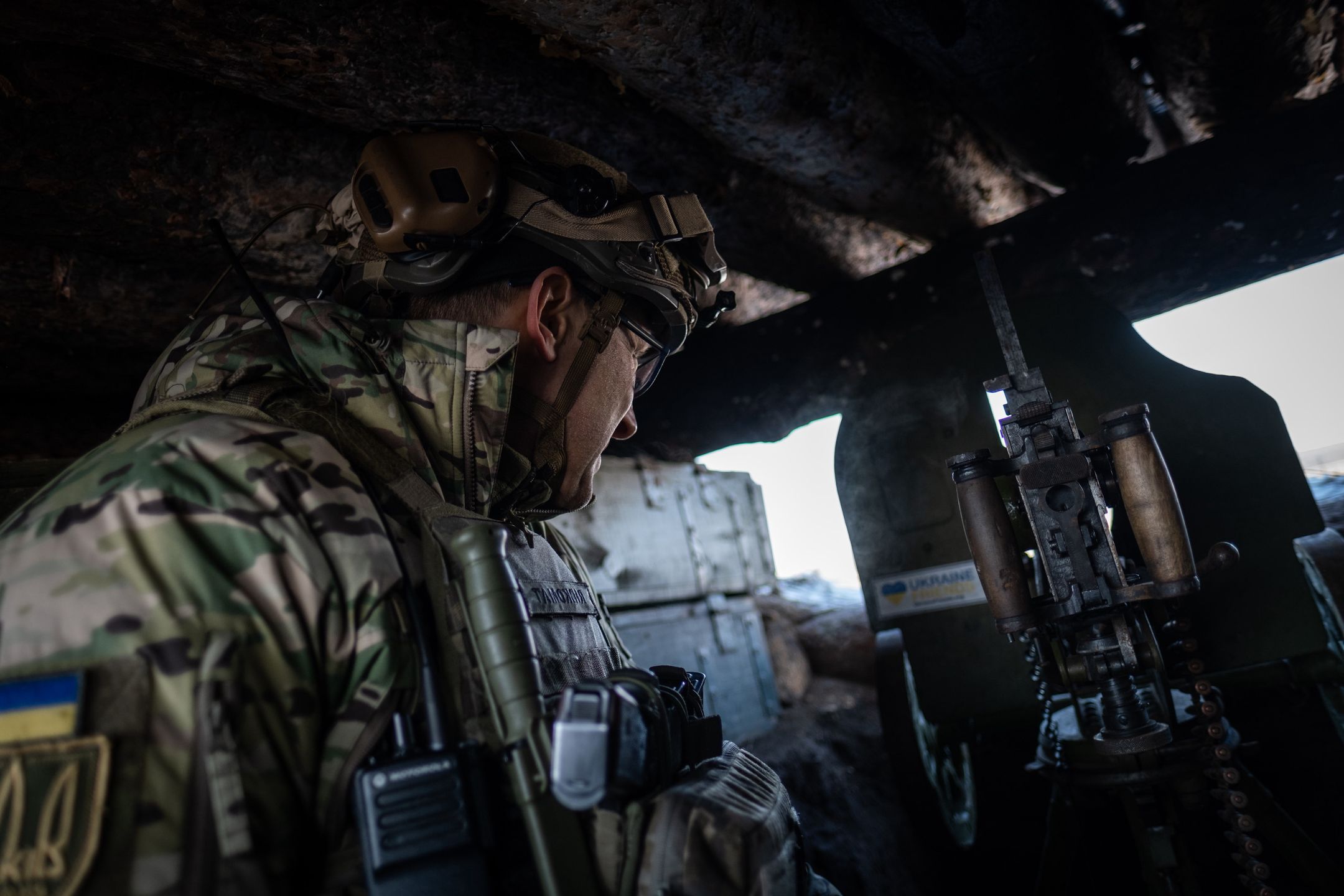 KHARKIV, UKRAINE - FEBRUARY 20: A Ukrainian soldier observes the Russian positions, located a couple of kilometers away, from a machine gun nest in the closest observation post to the Russian border in Kharkiv, Ukraine on February 20, 2023. Sometimes this observation position is attacked with a tank fire from the other side of the border. (Photo by Andres Gutierrez/Anadolu Agency via Getty Images)